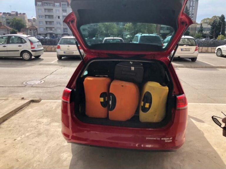suitcases in the trunk of a red car